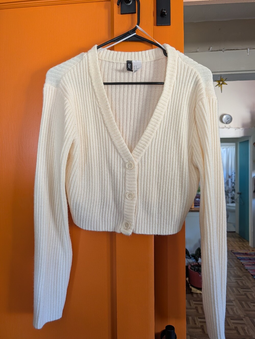 This is an H&M Divided cream ribbed knit cropped cardigan featuring a V-neckline